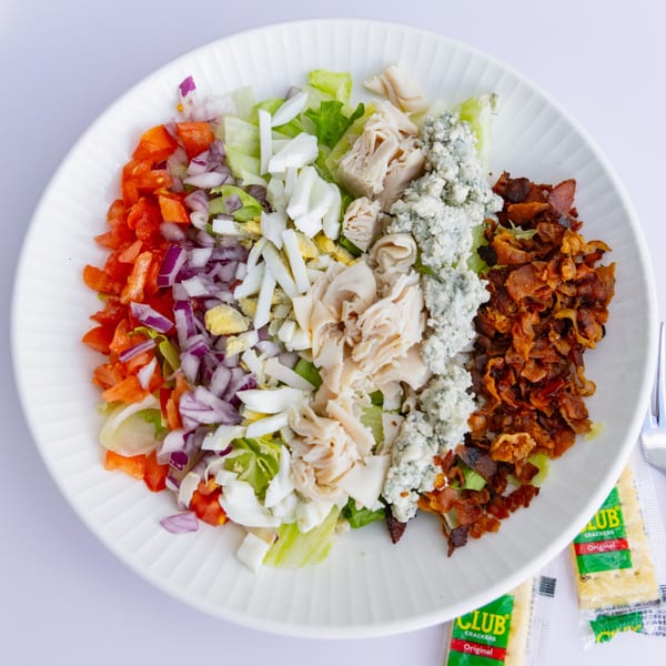 A Goldies Restaurant Cobb salad with bacon, chicken, blue cheese, egg, red onion, and tomato.